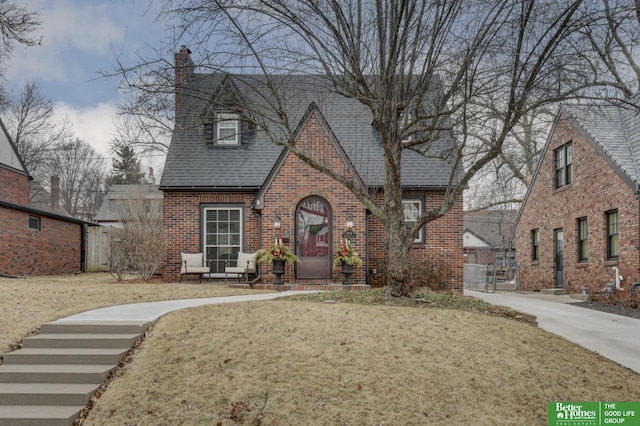 tudor house with a front lawn