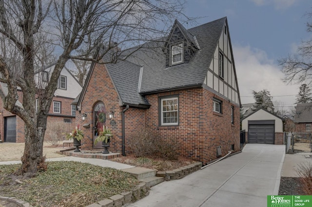 tudor-style house with a garage and an outbuilding