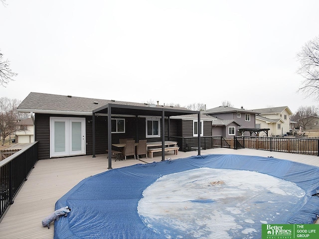 back of house featuring a wooden deck and french doors