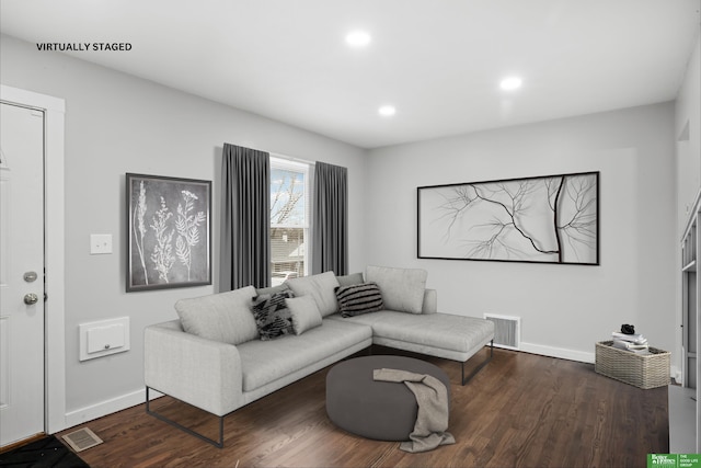 living room with dark hardwood / wood-style flooring