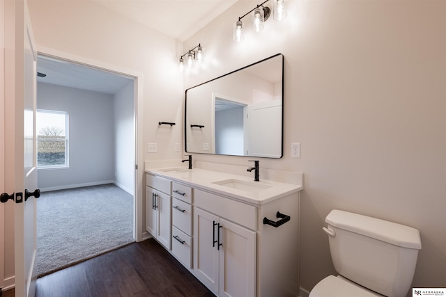 bathroom with vanity, wood-type flooring, and toilet