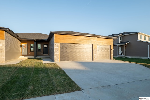 view of front of home featuring a garage and a front lawn