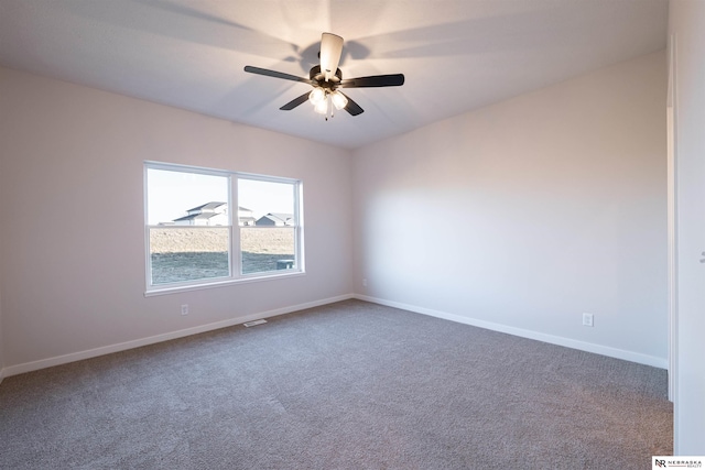 spare room with carpet and ceiling fan