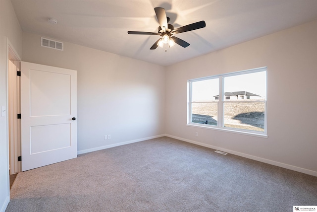 spare room with carpet flooring and ceiling fan