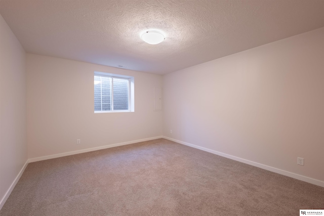 empty room with a textured ceiling and carpet