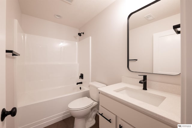 full bathroom featuring vanity, hardwood / wood-style floors, bathing tub / shower combination, and toilet