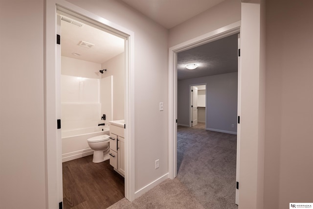 full bathroom with vanity, bathing tub / shower combination, a textured ceiling, and toilet