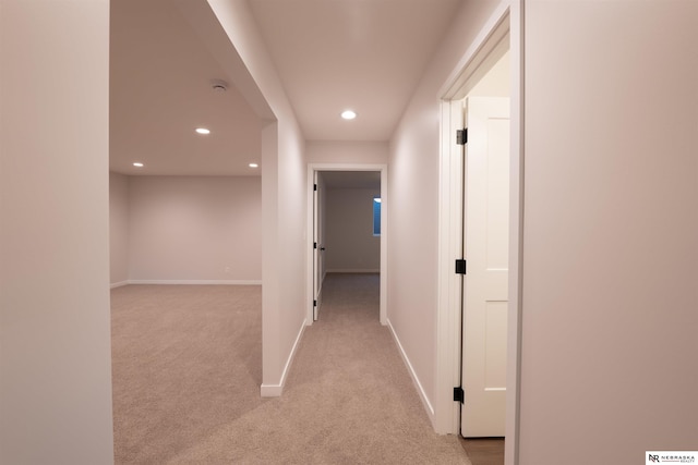 corridor featuring light colored carpet