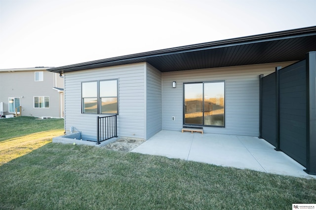 back of property featuring a yard and a patio area