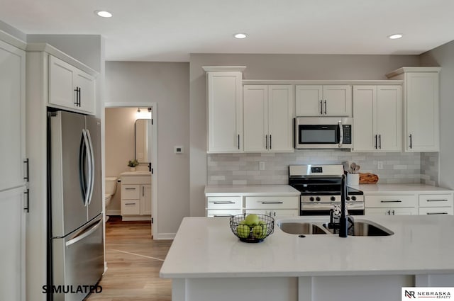 kitchen featuring white cabinetry, appliances with stainless steel finishes, and light countertops