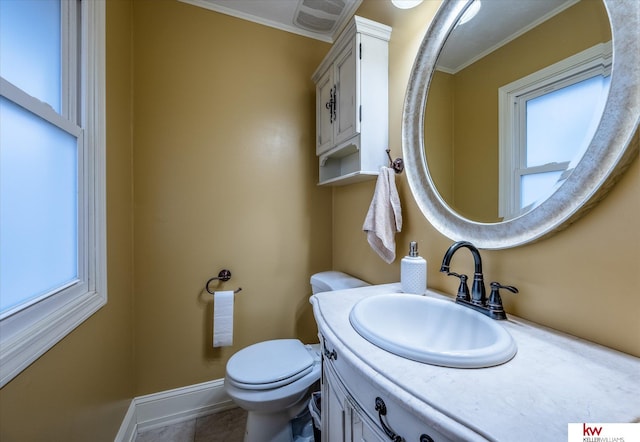 bathroom featuring vanity, crown molding, and toilet