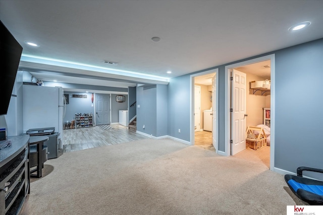 basement featuring light colored carpet