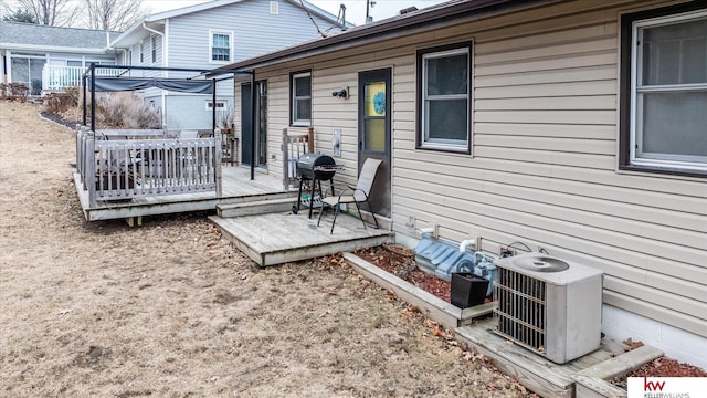 wooden terrace featuring central AC unit and a grill