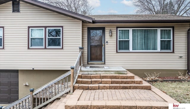 doorway to property featuring a garage