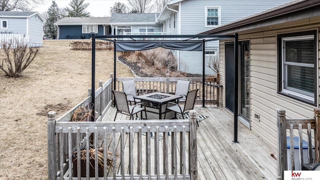 wooden terrace featuring an outdoor fire pit