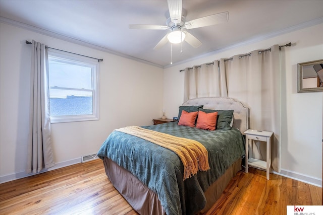 bedroom featuring crown molding, light hardwood / wood-style flooring, and ceiling fan