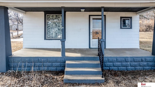 view of exterior entry with covered porch