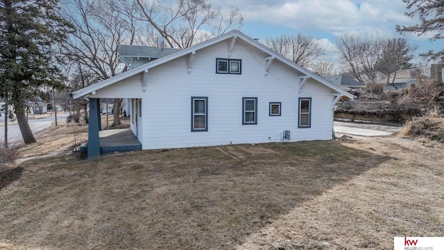 rear view of property with a patio and a lawn