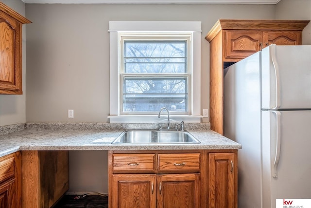 kitchen featuring white refrigerator and sink