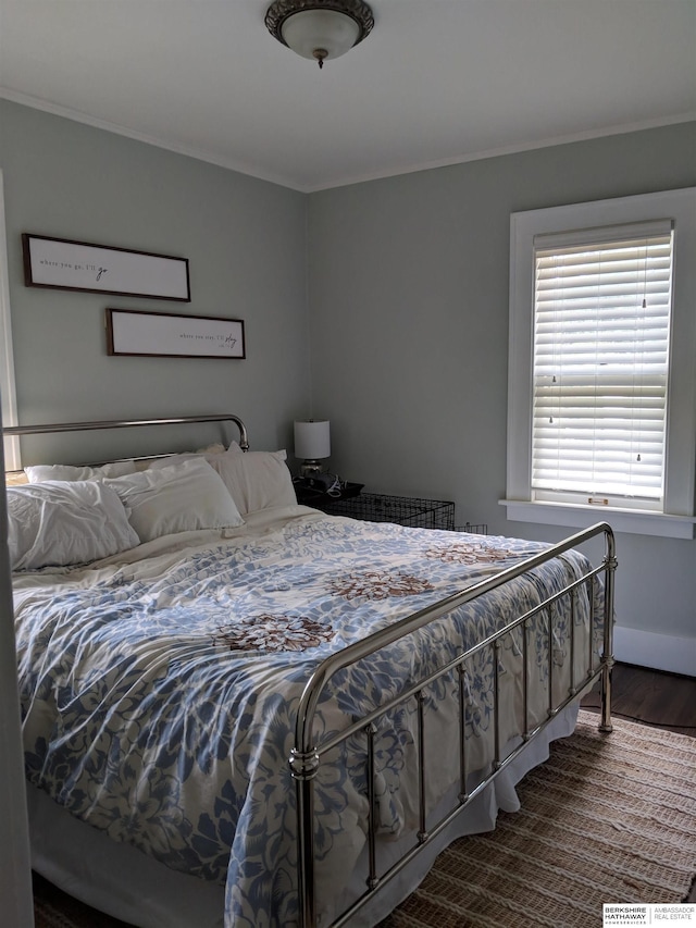 bedroom featuring hardwood / wood-style flooring and ornamental molding