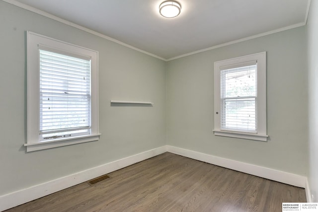 unfurnished room featuring hardwood / wood-style floors and ornamental molding