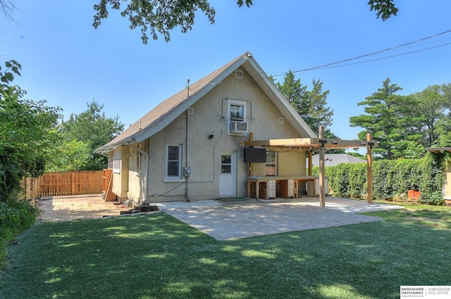 rear view of house with a yard and a patio area