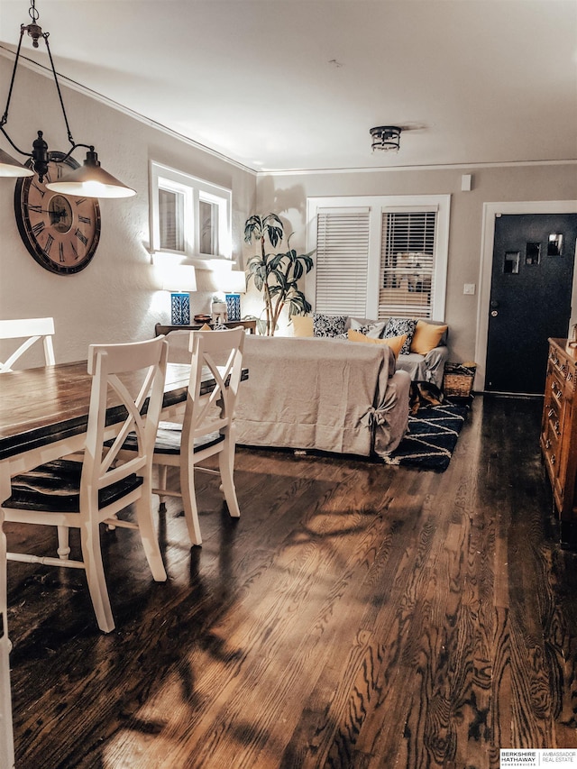 dining room with crown molding and dark hardwood / wood-style flooring