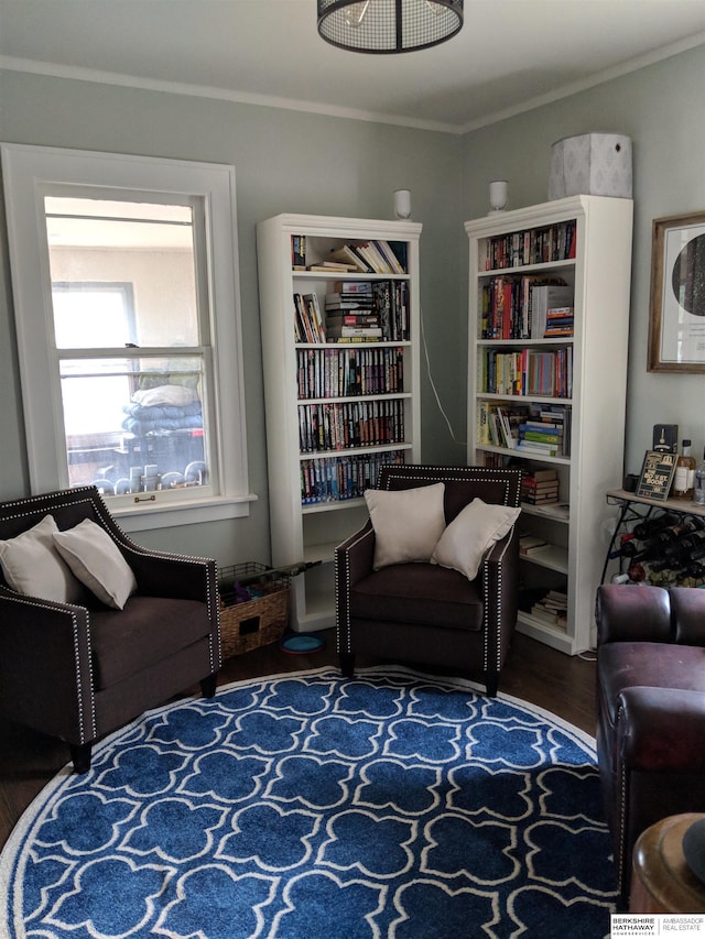 living area featuring crown molding and dark hardwood / wood-style floors