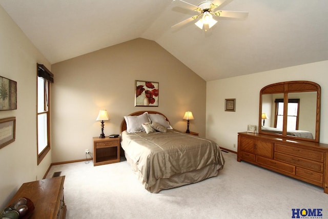 bedroom featuring ceiling fan, vaulted ceiling, and light carpet