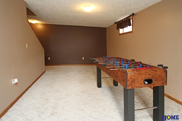 game room featuring a textured ceiling and carpet