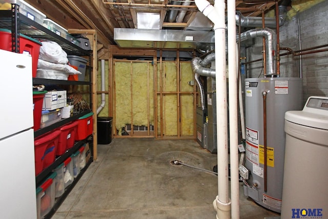 basement featuring white refrigerator and water heater