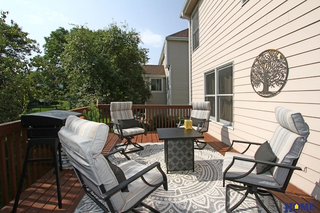 wooden deck featuring an outdoor fire pit