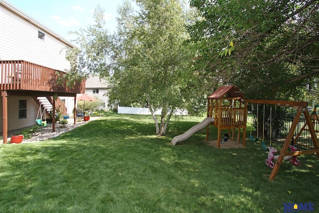 view of yard with a playground and a deck