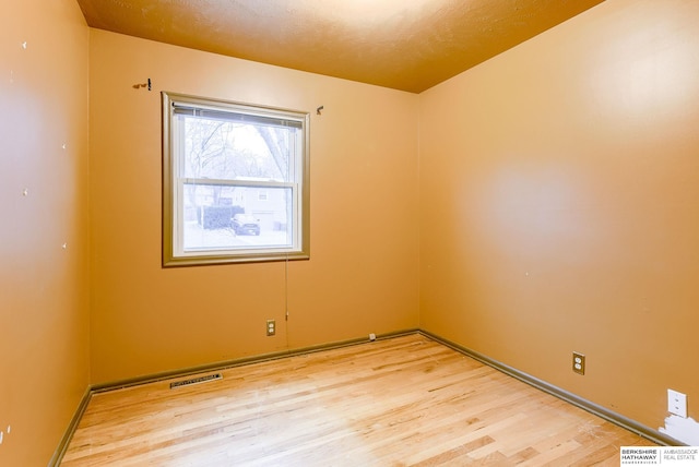 unfurnished room with light hardwood / wood-style floors