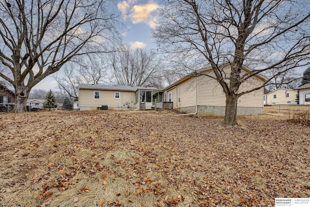 rear view of property with a sunroom