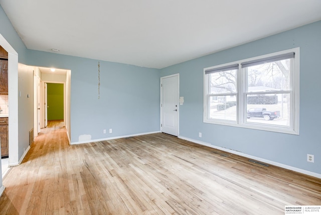 unfurnished room featuring light hardwood / wood-style floors