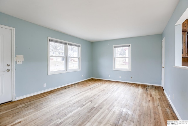 unfurnished room with light wood-type flooring