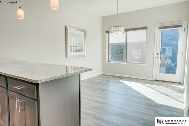 unfurnished dining area featuring light wood-type flooring