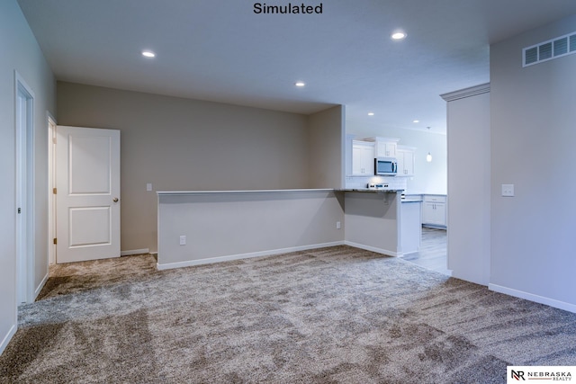 unfurnished room featuring light carpet