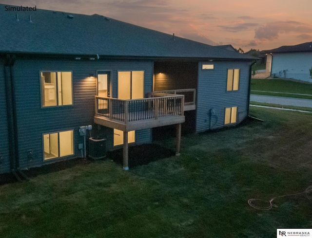 back house at dusk featuring a deck, central air condition unit, and a lawn