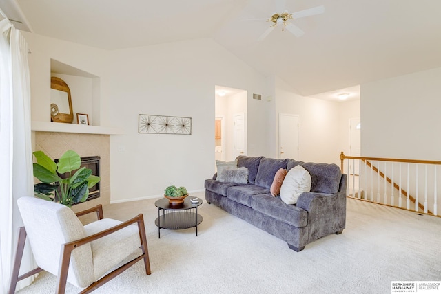 carpeted living room featuring lofted ceiling, a fireplace, and ceiling fan