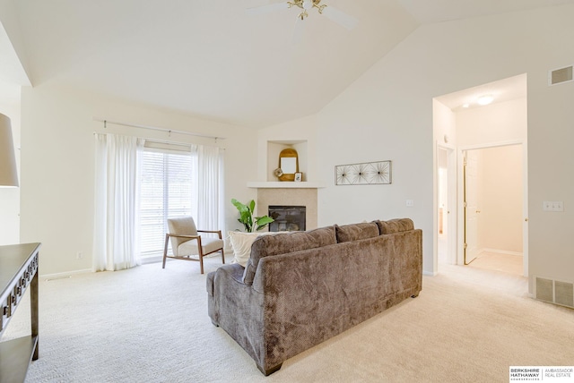 living room with high vaulted ceiling, light colored carpet, and ceiling fan