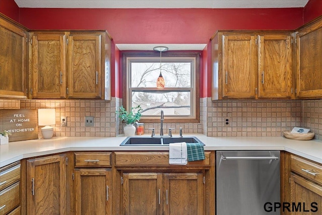 kitchen featuring sink, decorative backsplash, decorative light fixtures, and dishwasher