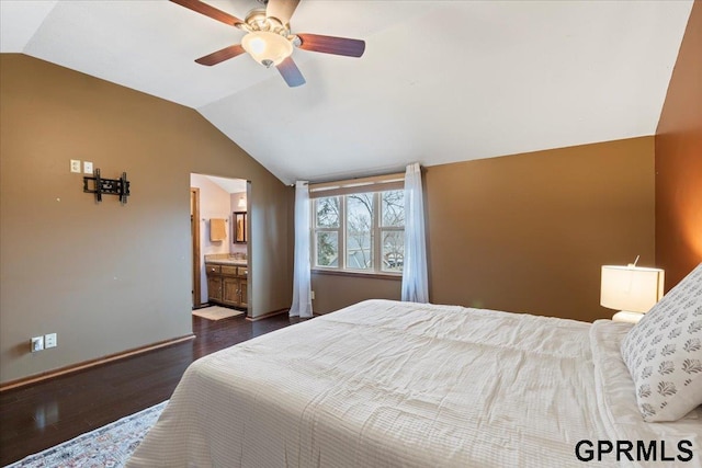 bedroom with ceiling fan, lofted ceiling, dark hardwood / wood-style flooring, and connected bathroom