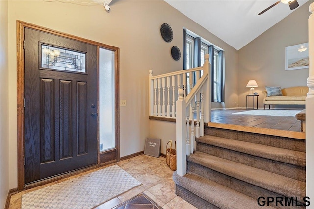 foyer entrance featuring ceiling fan and vaulted ceiling