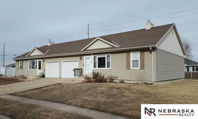 single story home with a garage and a front lawn