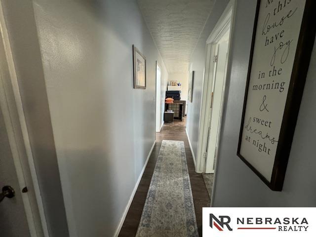 corridor featuring dark hardwood / wood-style floors