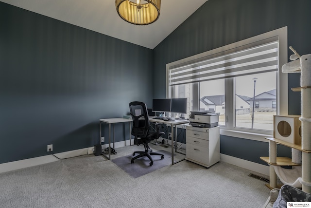 office area featuring light colored carpet and vaulted ceiling