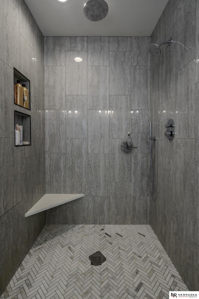 bathroom with tiled shower