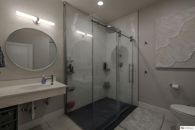 bathroom featuring tile patterned flooring, sink, an enclosed shower, and toilet